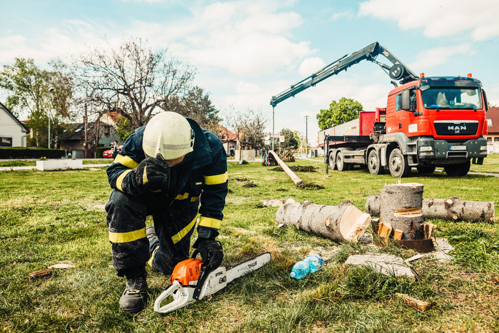 Crew member preparing equipment beside a truck